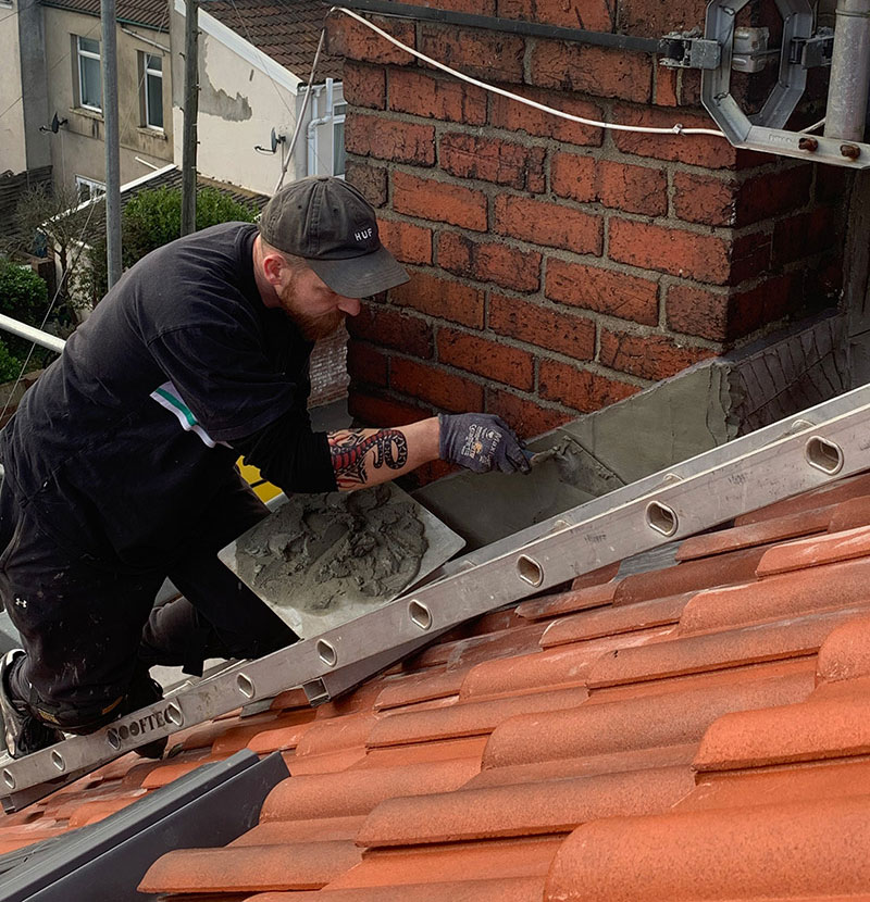 Ollie rendering the side of the parapet, Albion Roofing, Bristol.