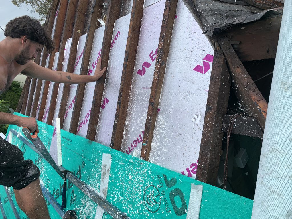Installing rigid insulation between rafters, Brislington, Albion Roofing.