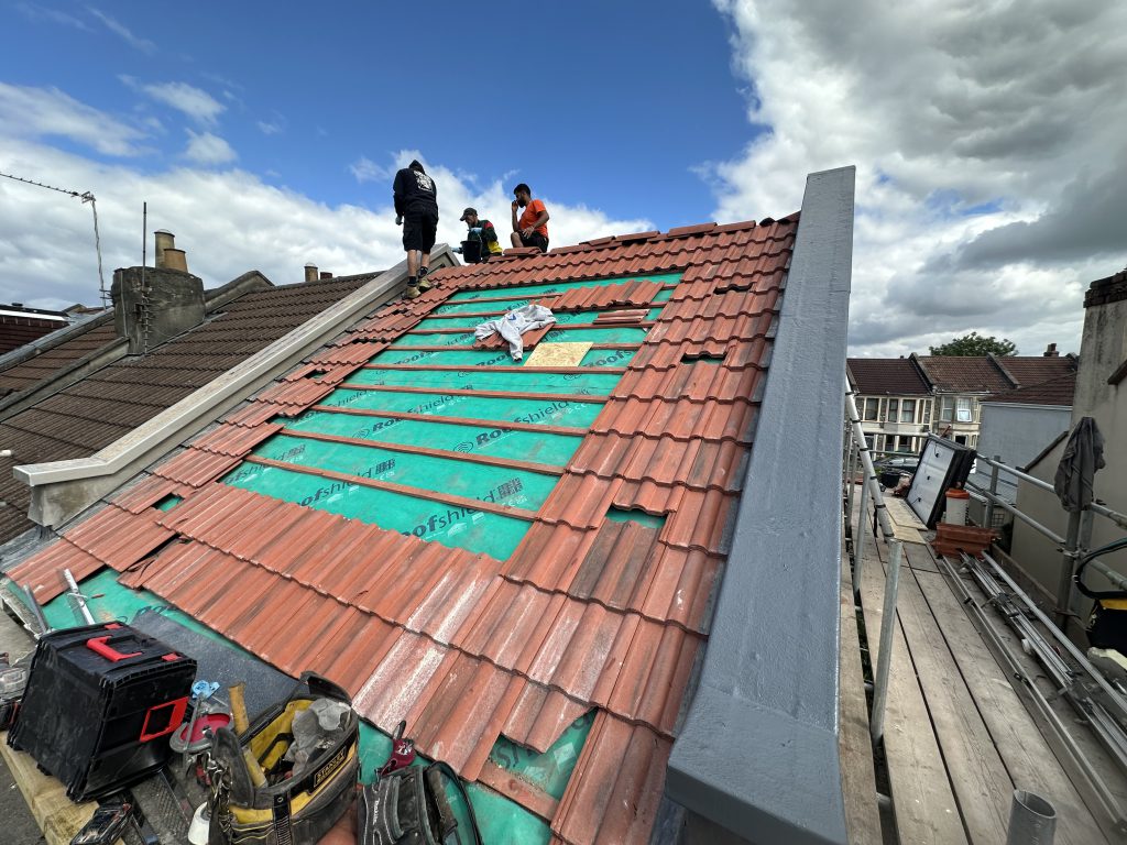 Roofers installing clay tiles and underlay, Hill Street, Bristol, Albion Roofing.