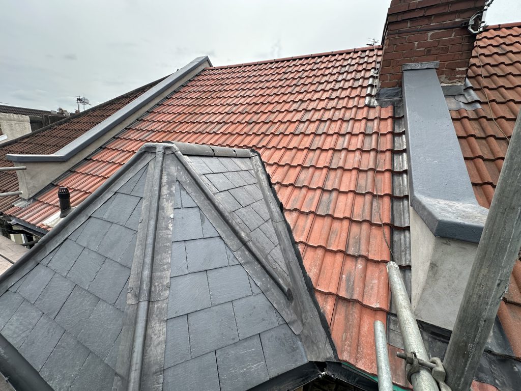 Slate hip detail next to clay tile roof, Bristol, Albion Roofing.