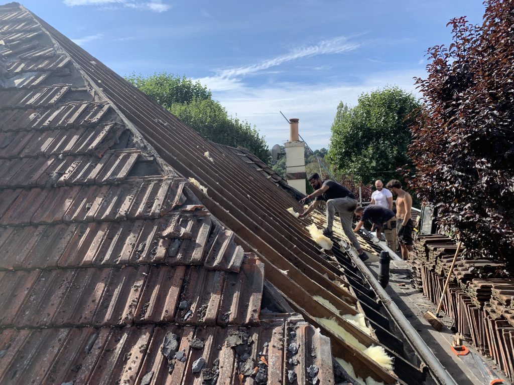 Team stripping old tiles during a re-roof, Brislington, Albion Roofing.