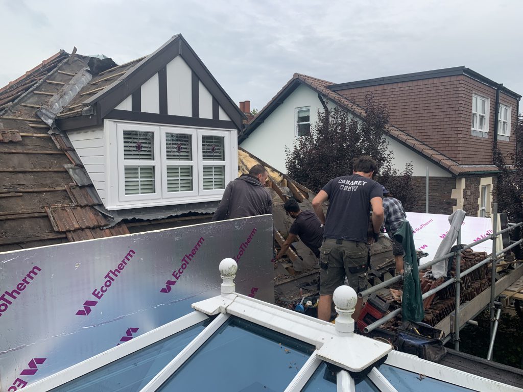 Team working on roof with insulation boards, Brislington, Albion Roofing.